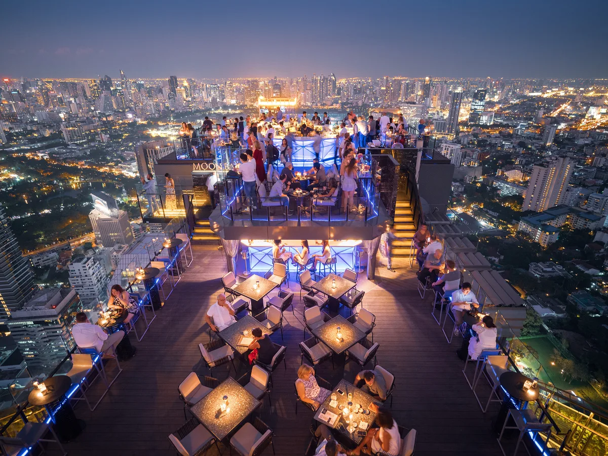 ดาดฟ้าร้านอาหารเปิดโล่งเต็มไปด้วยแขกยามค่ำคืน